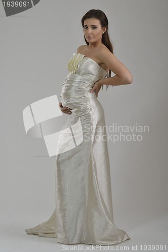 Image of elegant woman in fashionable dress posing in the studio