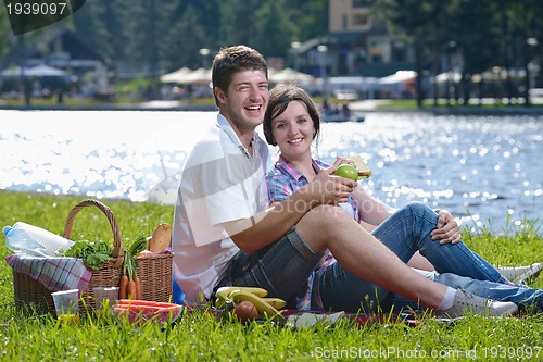 Image of happy young couple having a picnic outdoor