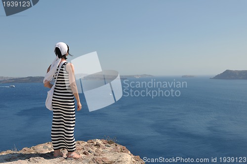 Image of Greek woman on the streets of Oia, Santorini, Greece