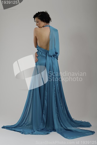 Image of elegant woman in fashionable dress posing in the studio