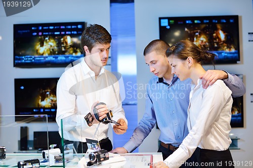 Image of Young couple in consumer electronics store