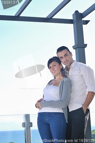 Image of couple relaxing on balcony