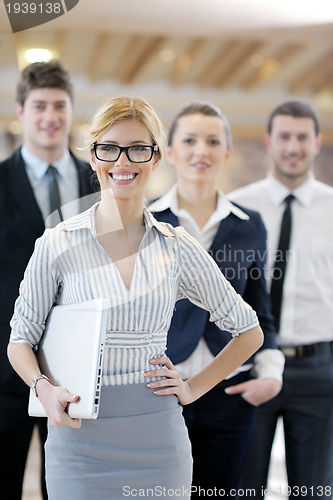 Image of business woman standing with her staff at conference