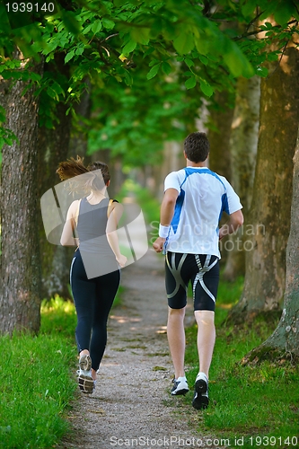 Image of Young couple jogging