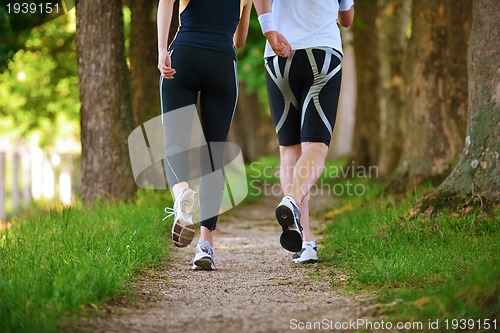 Image of Young couple jogging at morning