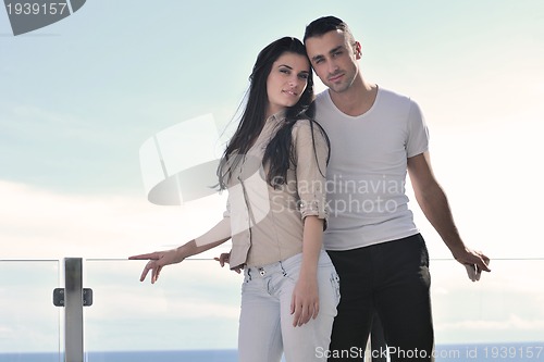 Image of couple relaxing on balcony