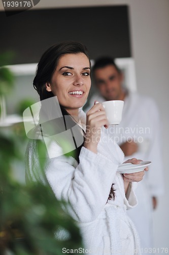 Image of Young love couple taking fresh morning cup of coffee