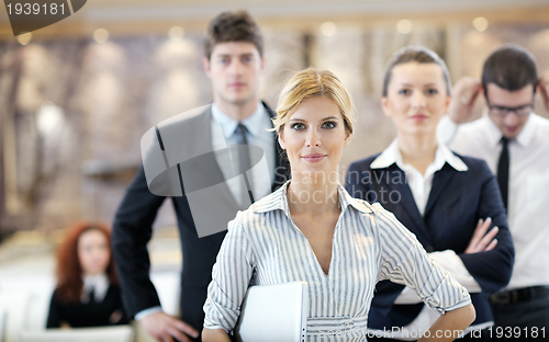 Image of business woman standing with her staff at conference