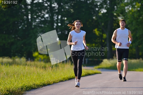 Image of Young couple jogging