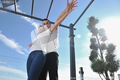 Image of couple relaxing on balcony