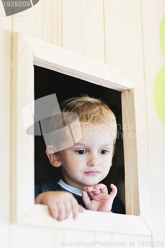 Image of happy child in a window