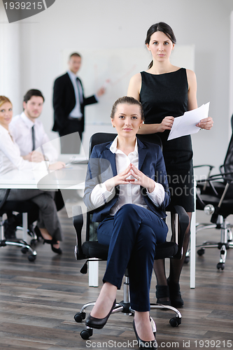 Image of business woman with her staff in background