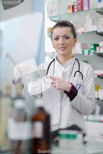Image of pharmacist chemist woman standing in pharmacy drugstore