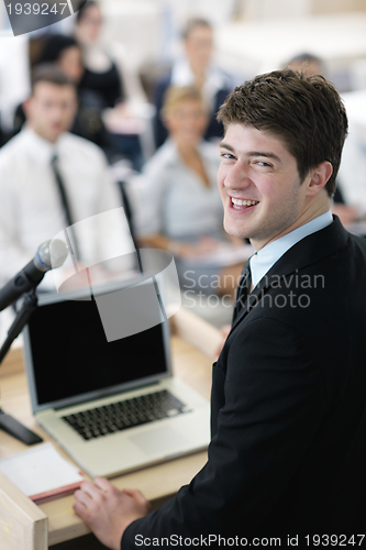 Image of Young  business man giving a presentation on conference