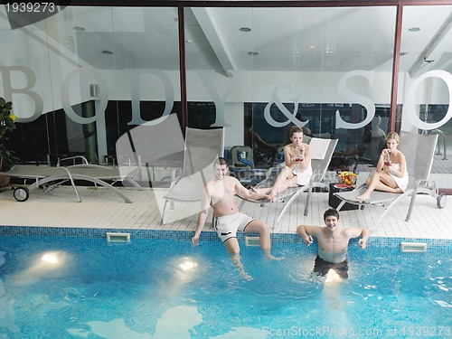 Image of young people group at spa swimming pool