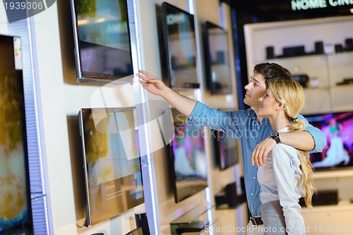 Image of Young couple in consumer electronics store