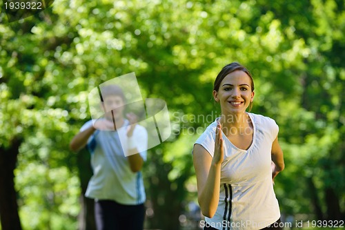 Image of Young couple jogging at morning