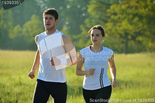 Image of Young couple jogging at morning