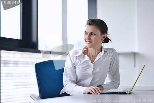 Image of Young pretty business woman with notebook in the office