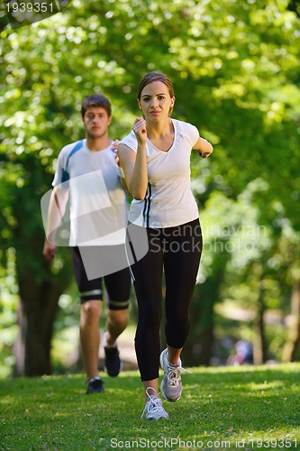 Image of Young couple jogging at morning