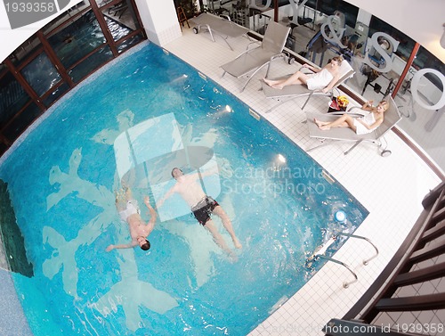 Image of young people group at spa swimming pool