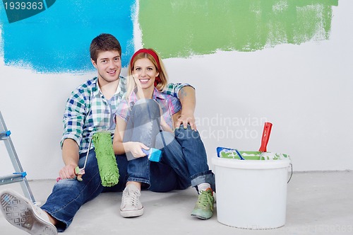 Image of happy young cople relaxing after painting in new home