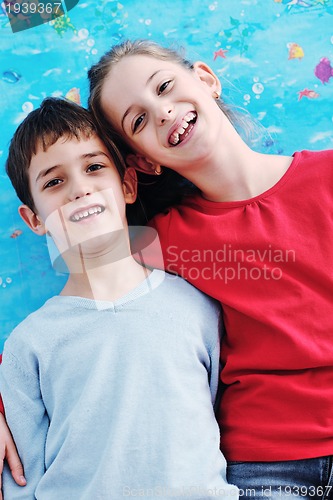 Image of portrait of happy brother and sister at home