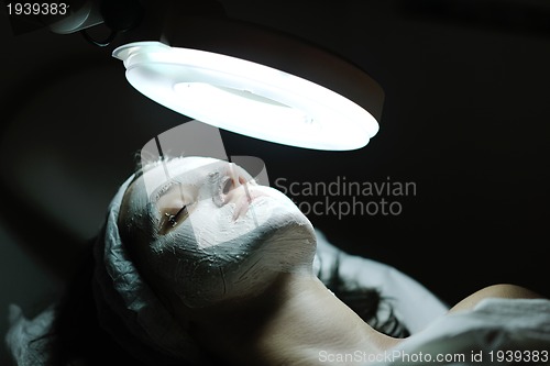 Image of woman with facial mask in cosmetic studio