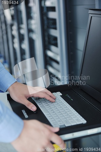 Image of young it engeneer in datacenter server room