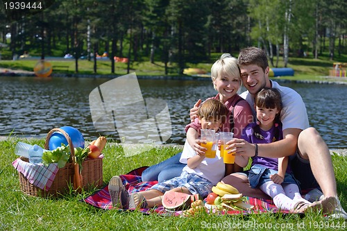 Image of Happy family playing together in a picnic outdoors