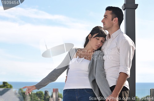 Image of couple relaxing on balcony