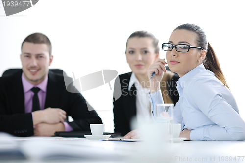 Image of business woman standing with her staff in background