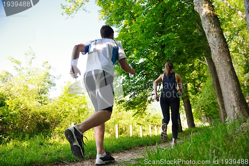 Image of Young couple jogging