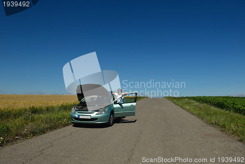 Image of woman with broken car