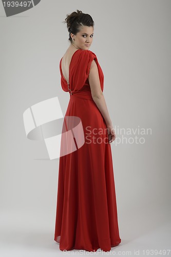 Image of elegant woman in fashionable dress posing in the studio