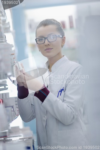 Image of pharmacist chemist woman standing in pharmacy drugstore