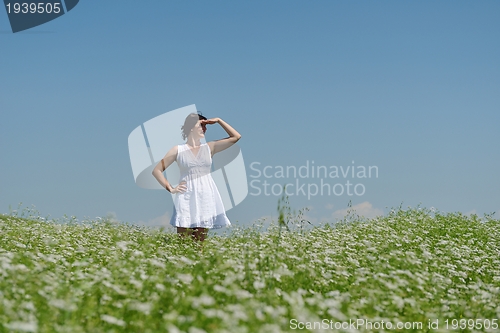 Image of Young happy woman in green field