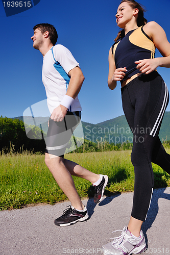 Image of Young couple jogging