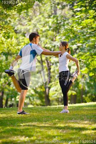 Image of Couple doing stretching exercise  after jogging