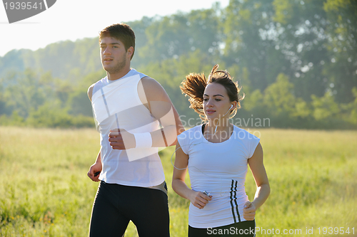 Image of Young couple jogging at morning