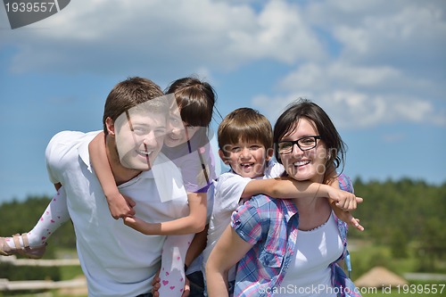 Image of happy young family have fun outdoors