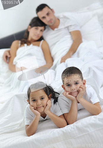 Image of happy young Family in their bedroom