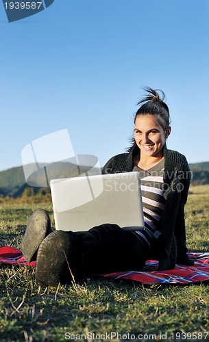 Image of young teen girl work on laptop outdoor