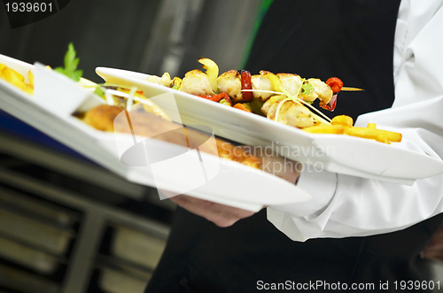 Image of male chef presenting food