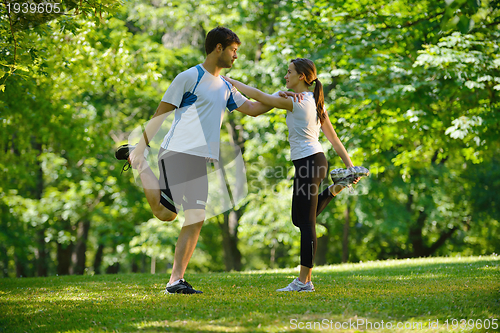 Image of Couple doing stretching exercise  after jogging