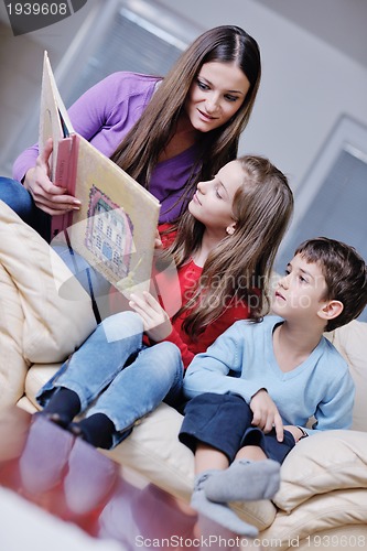Image of young mom play with their kids at home and reading book