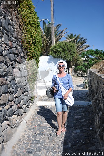 Image of Greek woman on the streets of Oia, Santorini, Greece