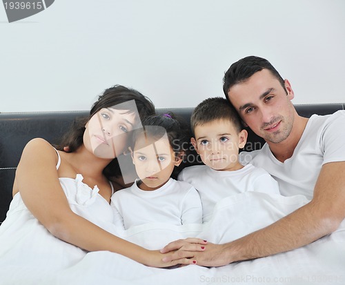 Image of happy young Family in their bedroom