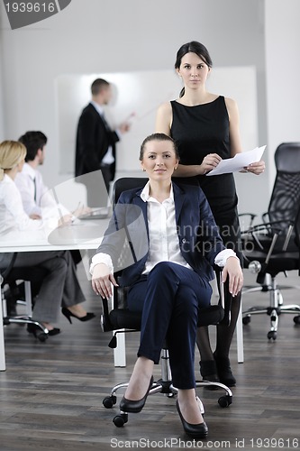 Image of business woman with her staff in background