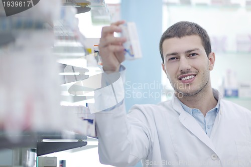 Image of pharmacist chemist man in pharmacy drugstore